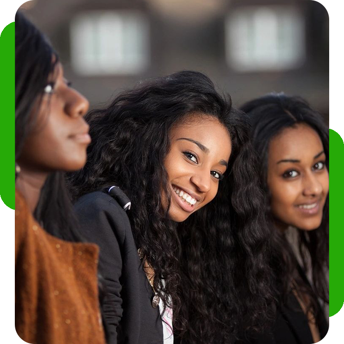 Three young women smiling for the camera.