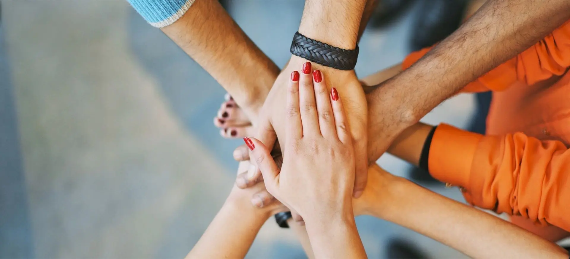 A group of people with their hands together.